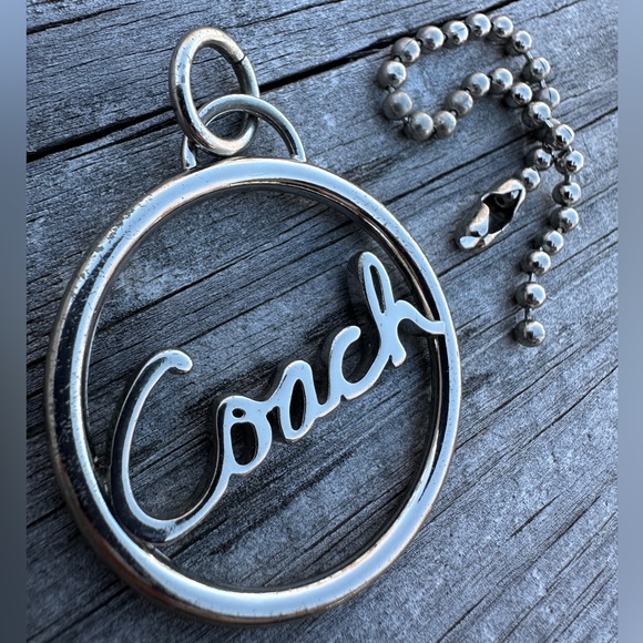 Coach Circular Silver Keychain
Coach Silver Circle Keychain – Timeless Elegance - Picture 13 of 16